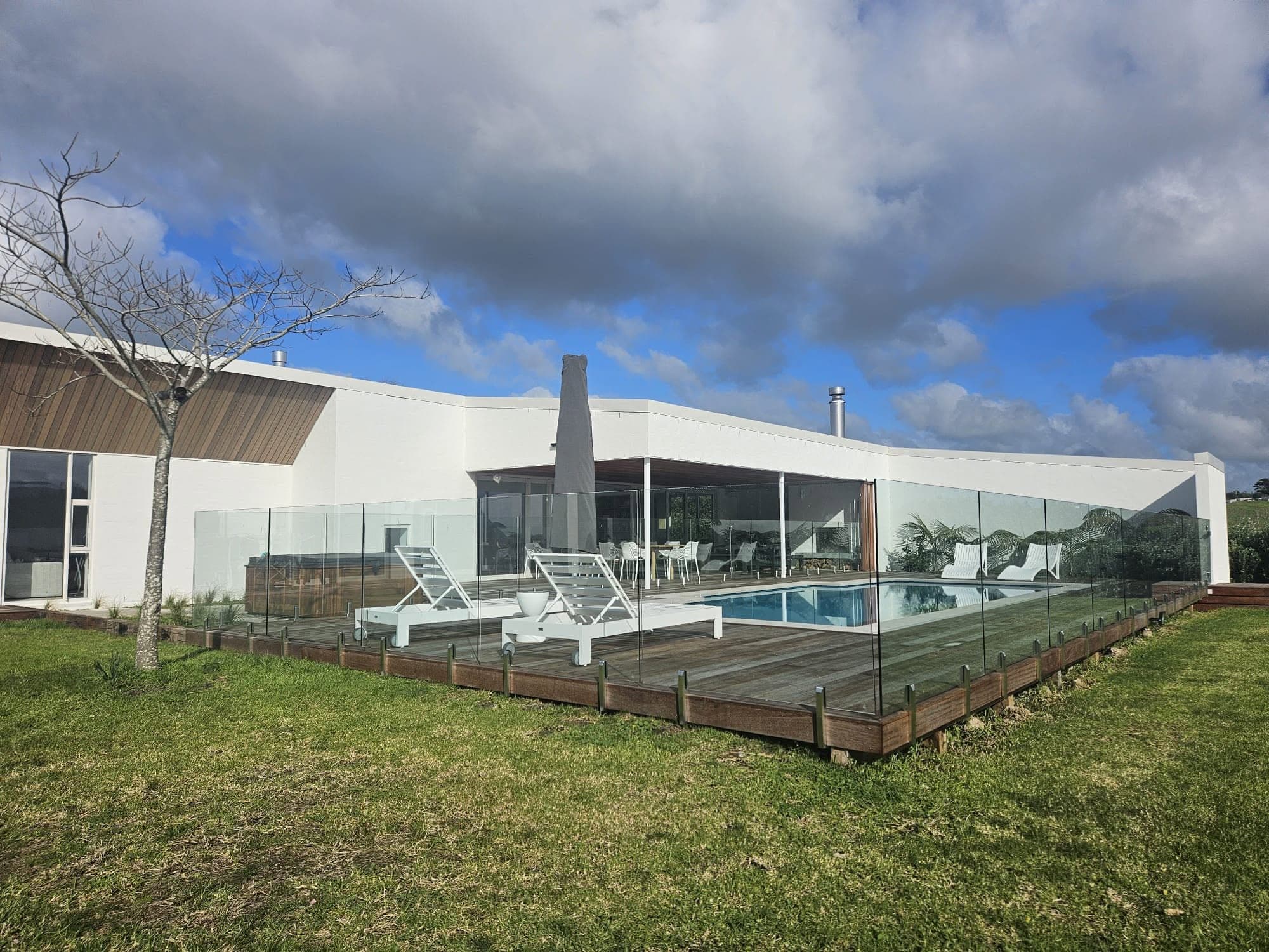Completed home with glass-fenced pool and deck