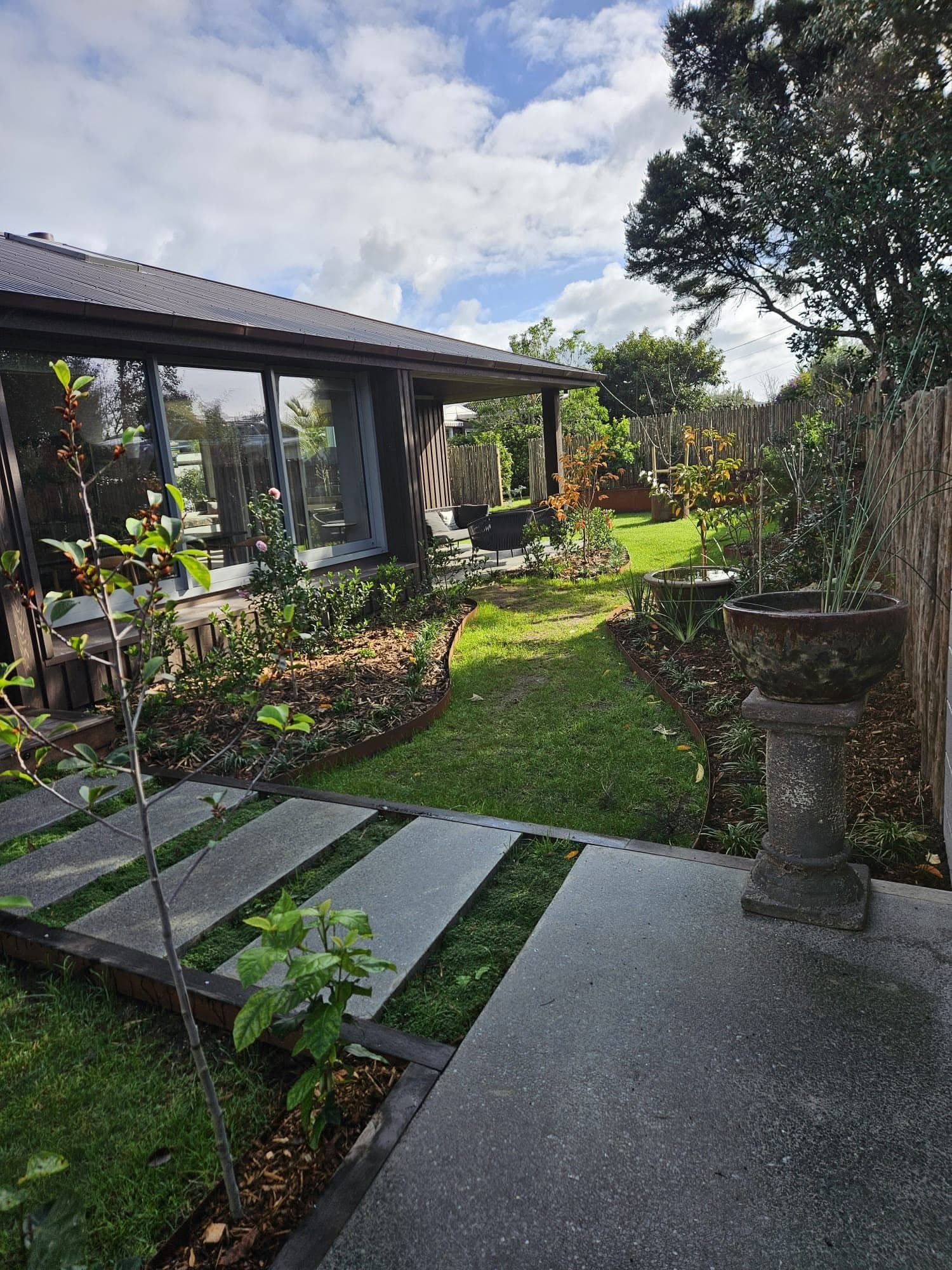 Landscaped garden path alongside a finished home